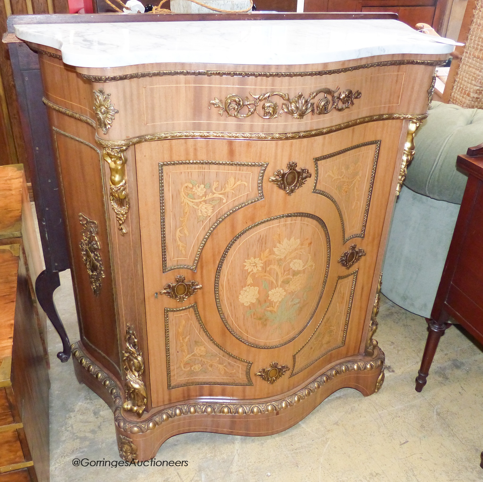 A Louis XV style marquetry inlaid, gilt metal mounted serpentine pier cabinet with white marble top. W-99, D-43, H-103cm.